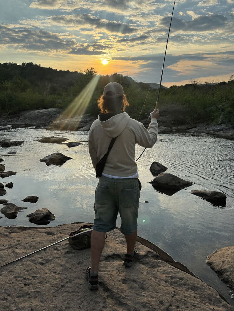 Angler working the whitewater below a dam