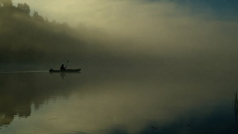 Rod and reel at a dawn lake