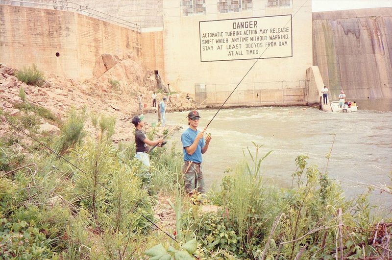 Anglers casting into the tailrace below a dam